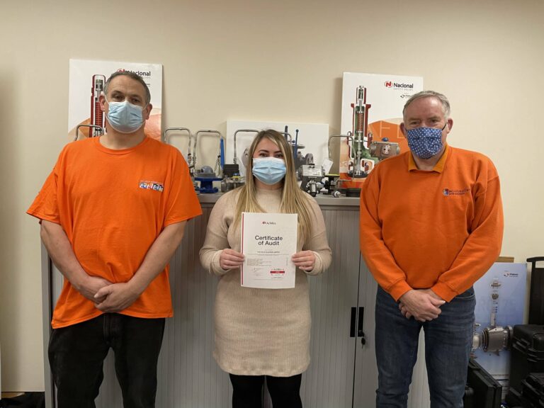 Team members displaying UVDB Certificate of Audit